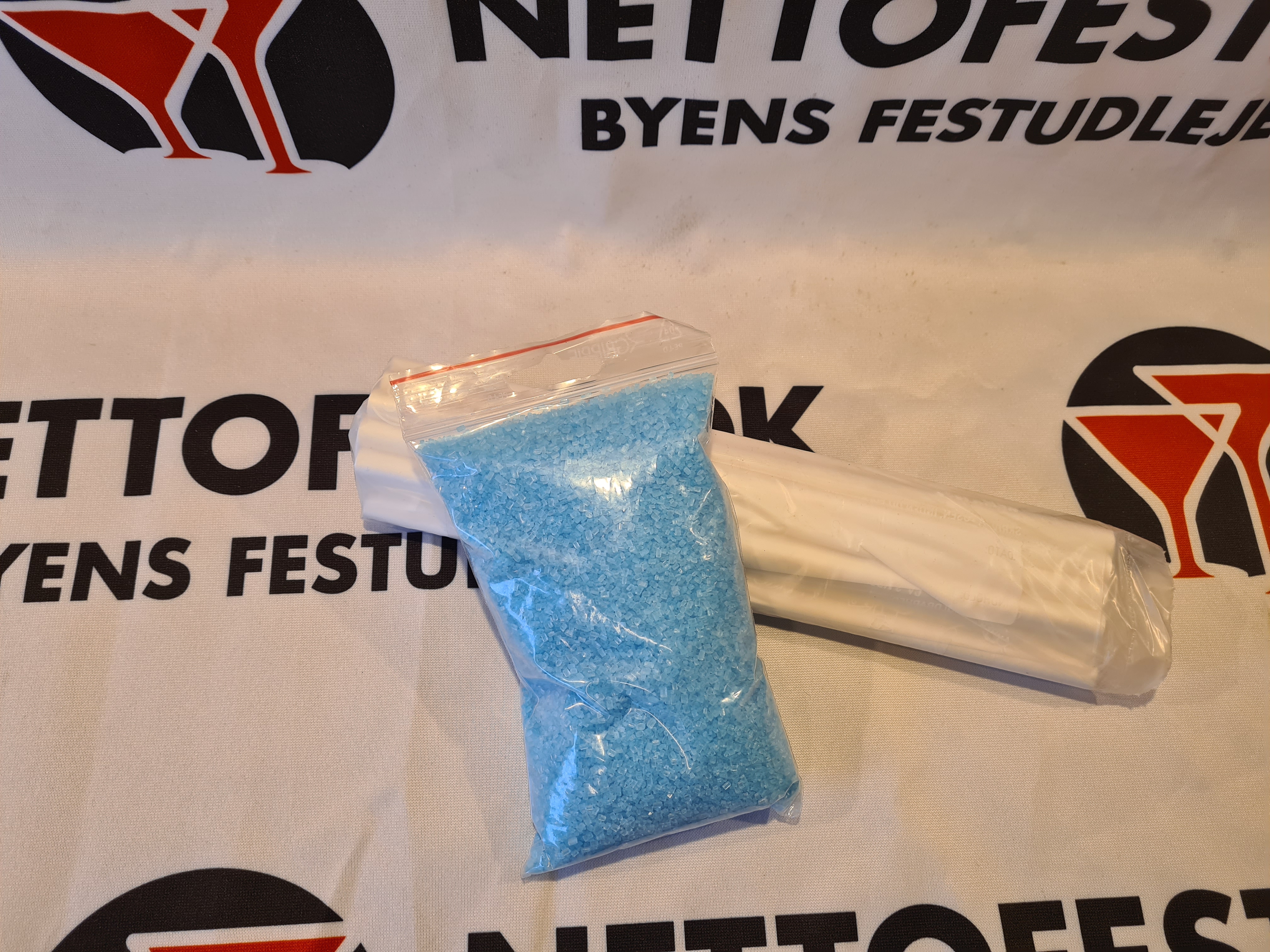 Eight shirts arranged on table in black, olive, grey, blue, white, red, mustard, and green.