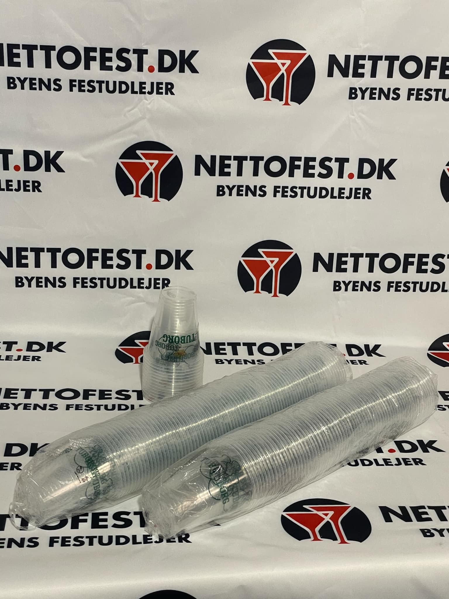 Eight shirts arranged on table in black, olive, grey, blue, white, red, mustard, and green.