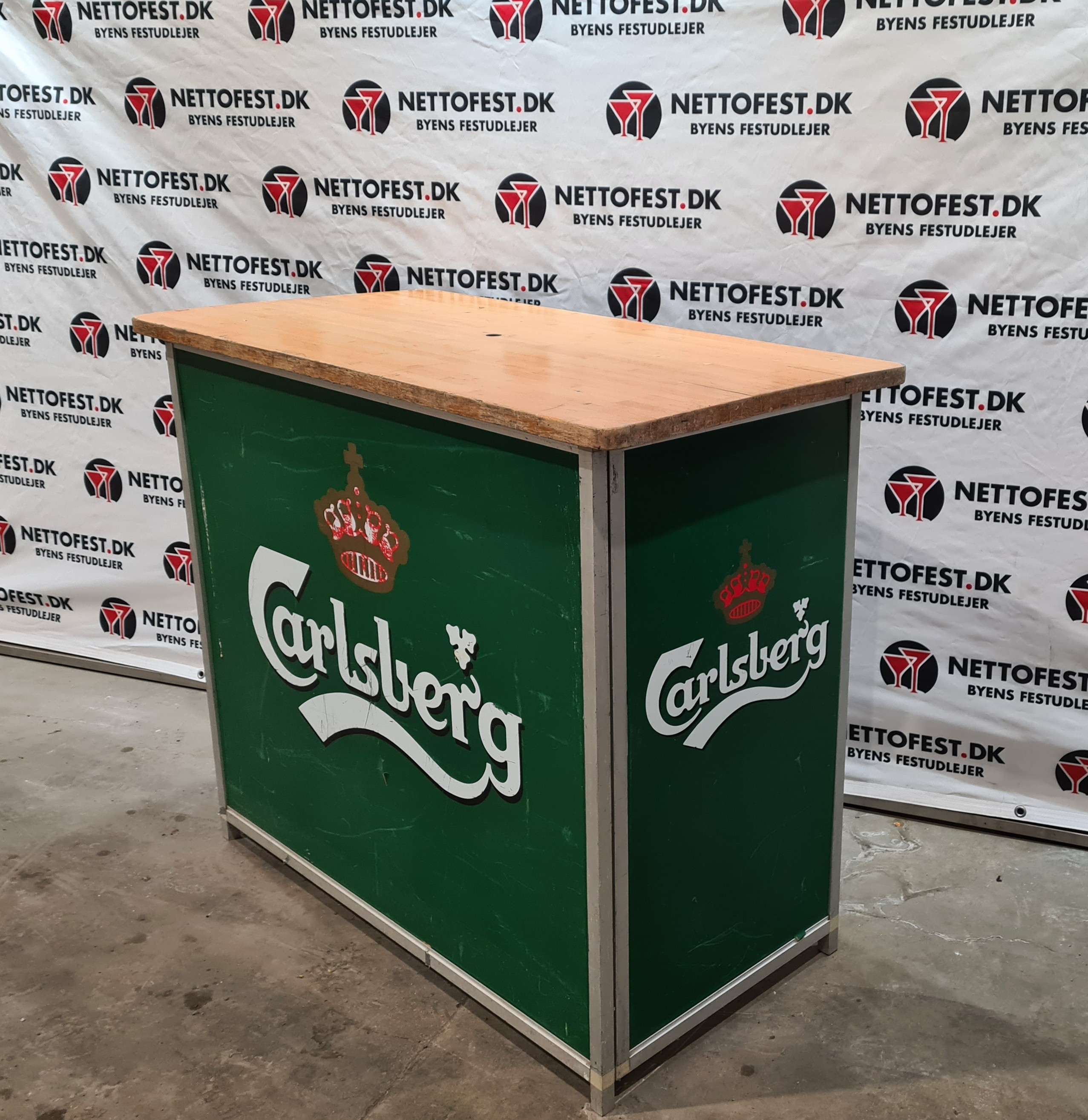 Eight shirts arranged on table in black, olive, grey, blue, white, red, mustard, and green.