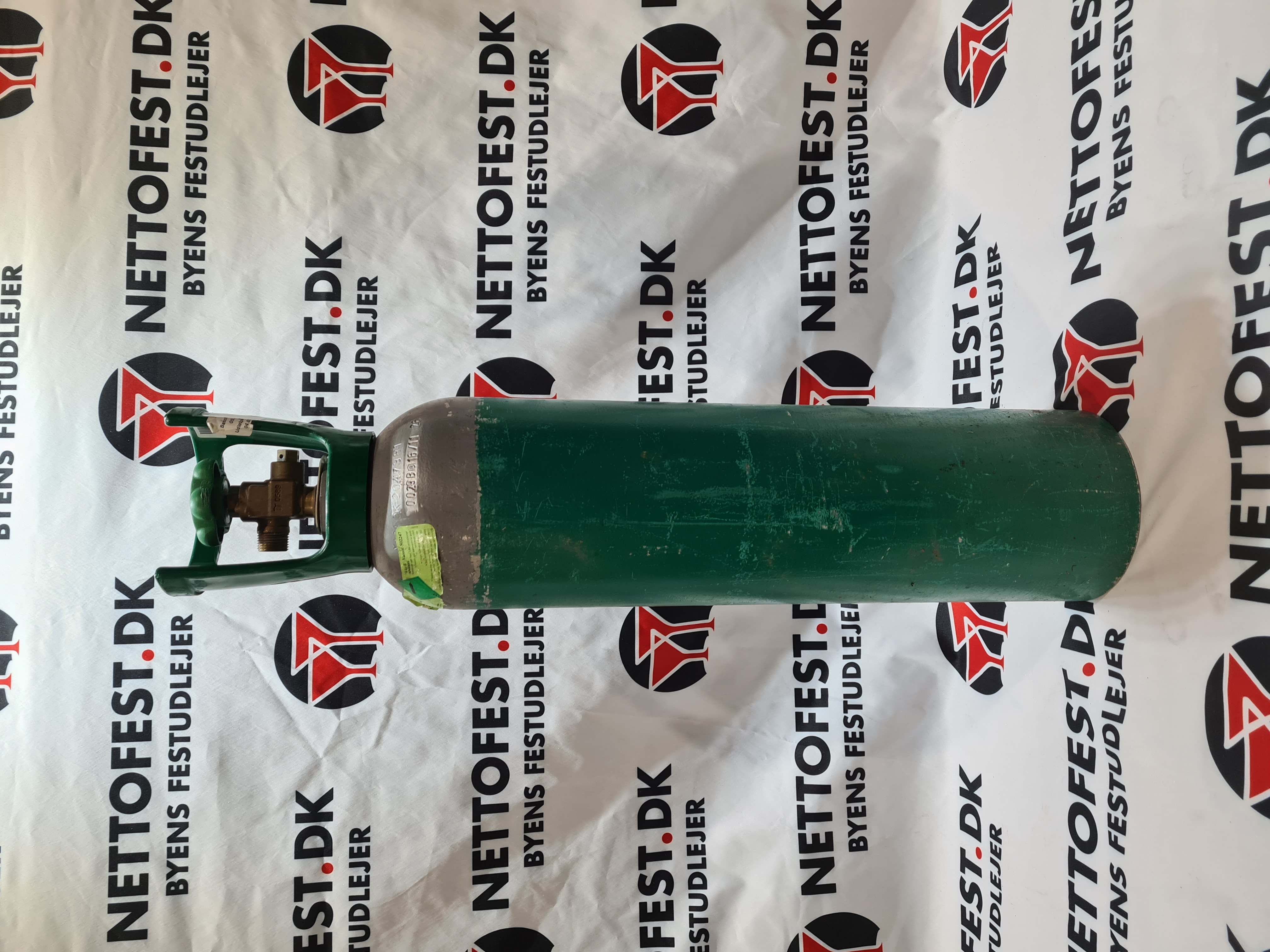 Eight shirts arranged on table in black, olive, grey, blue, white, red, mustard, and green.