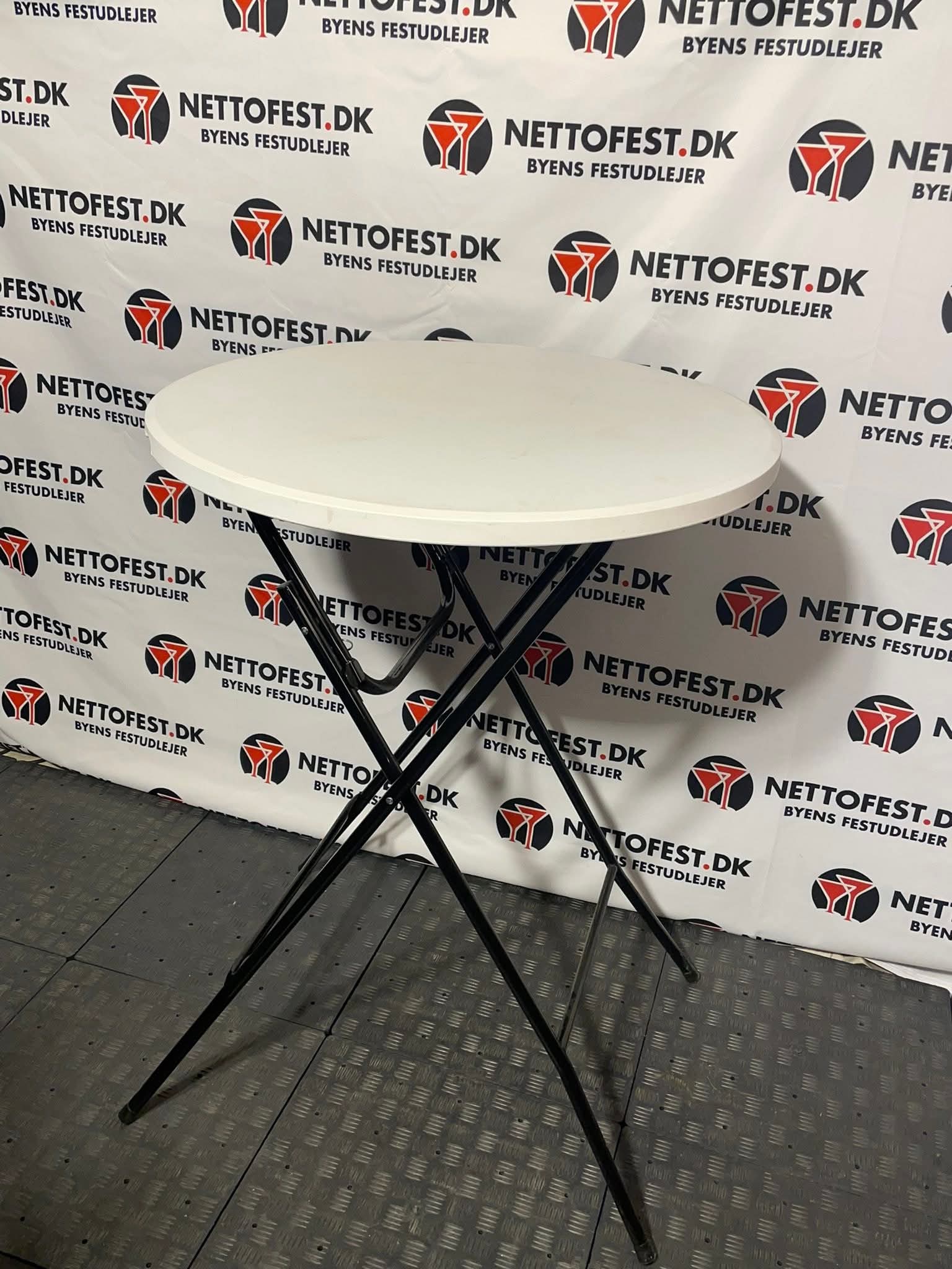 Eight shirts arranged on table in black, olive, grey, blue, white, red, mustard, and green.