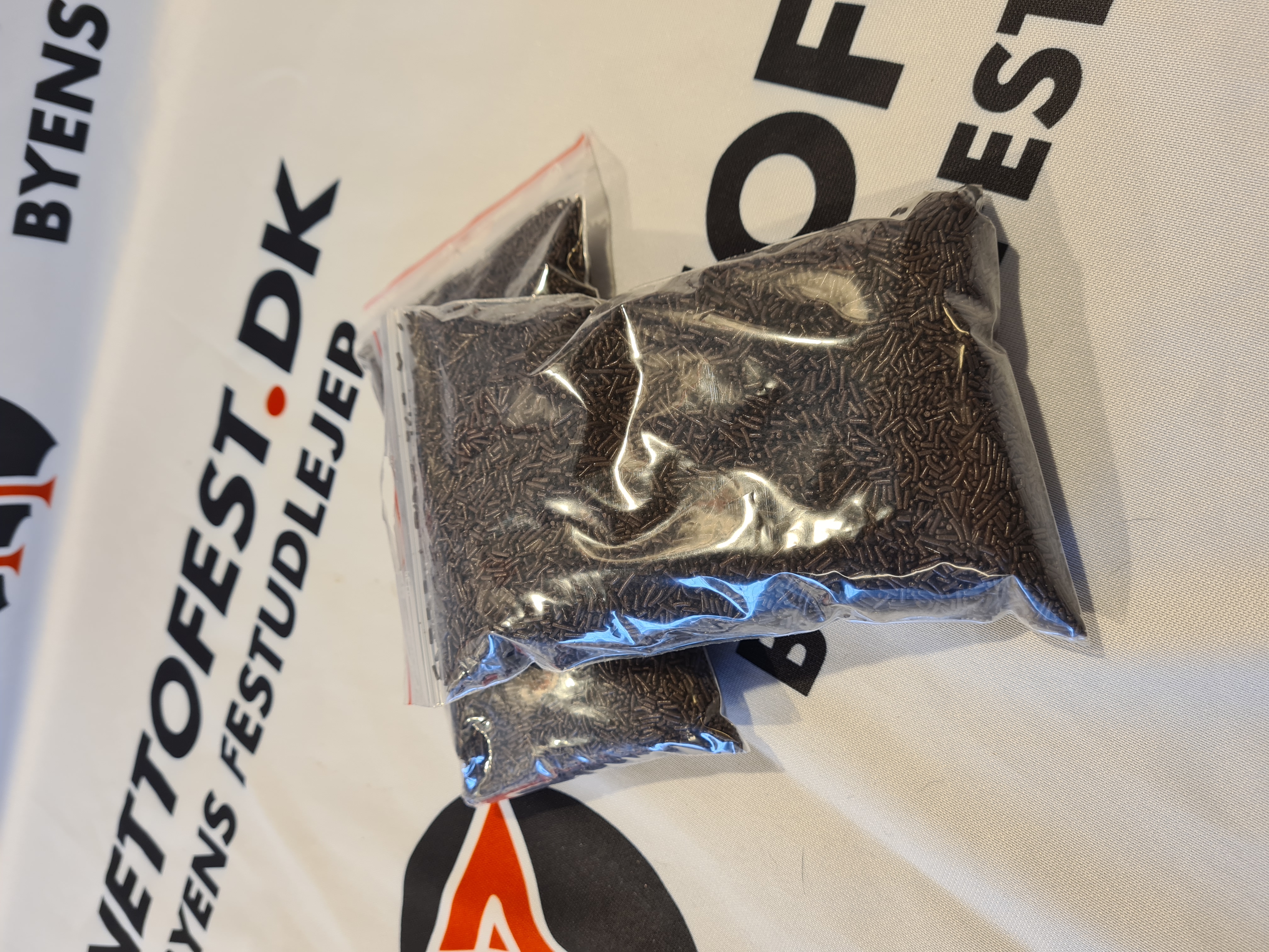 Eight shirts arranged on table in black, olive, grey, blue, white, red, mustard, and green.