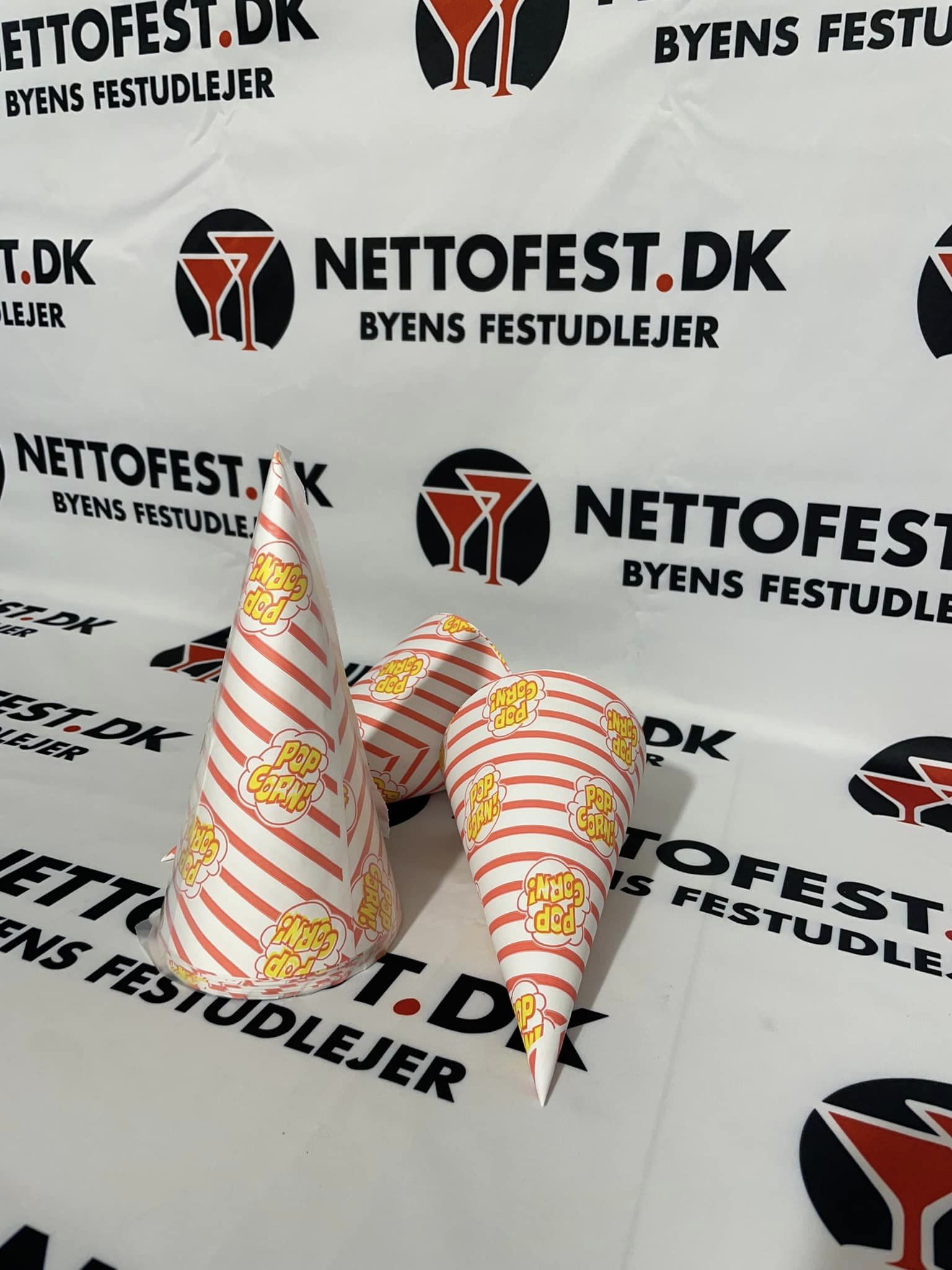 Eight shirts arranged on table in black, olive, grey, blue, white, red, mustard, and green.