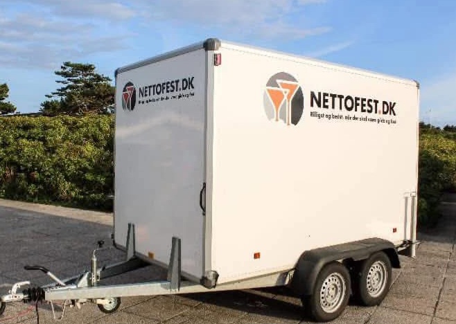 Eight shirts arranged on table in black, olive, grey, blue, white, red, mustard, and green.