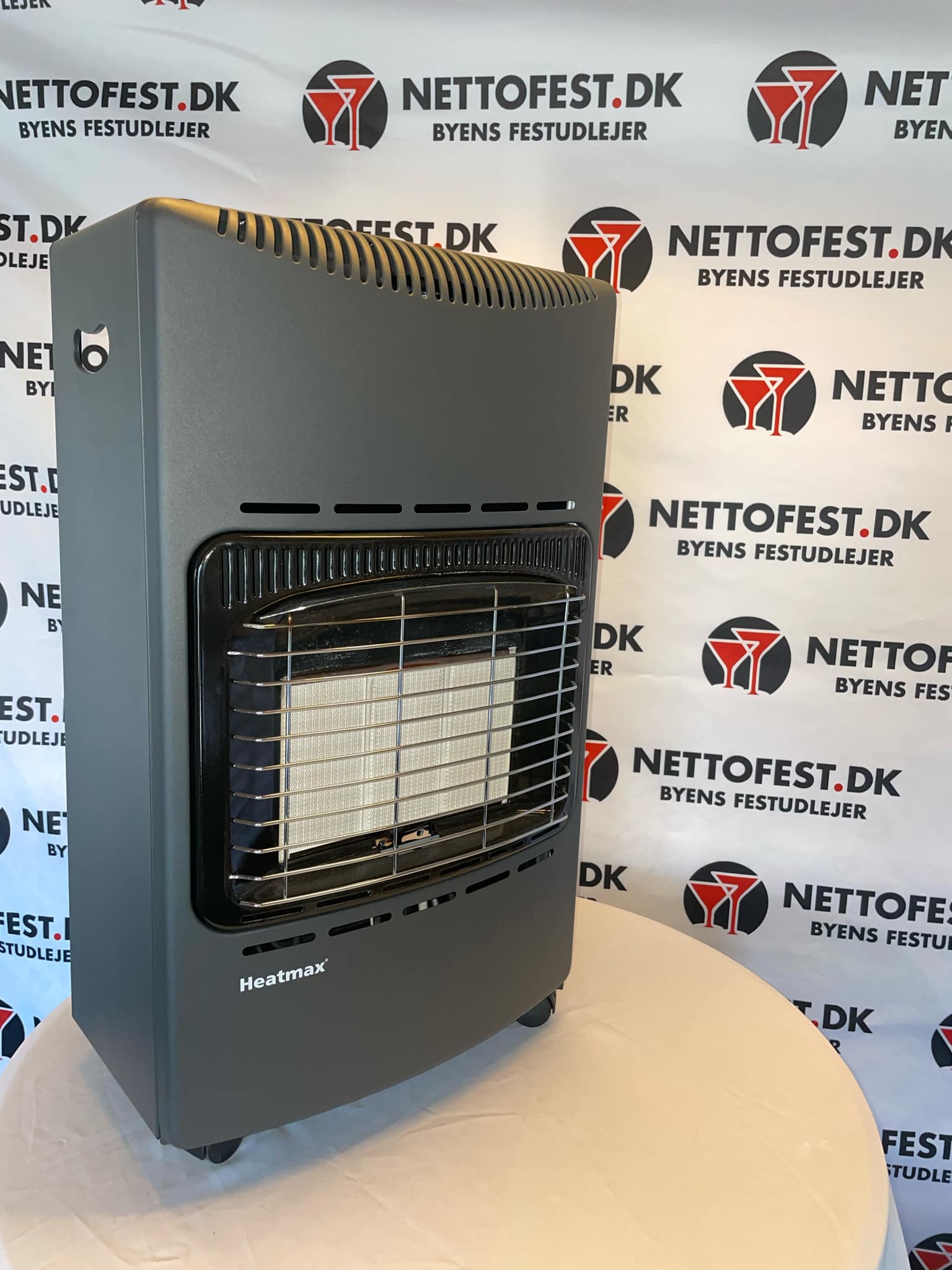 Eight shirts arranged on table in black, olive, grey, blue, white, red, mustard, and green.