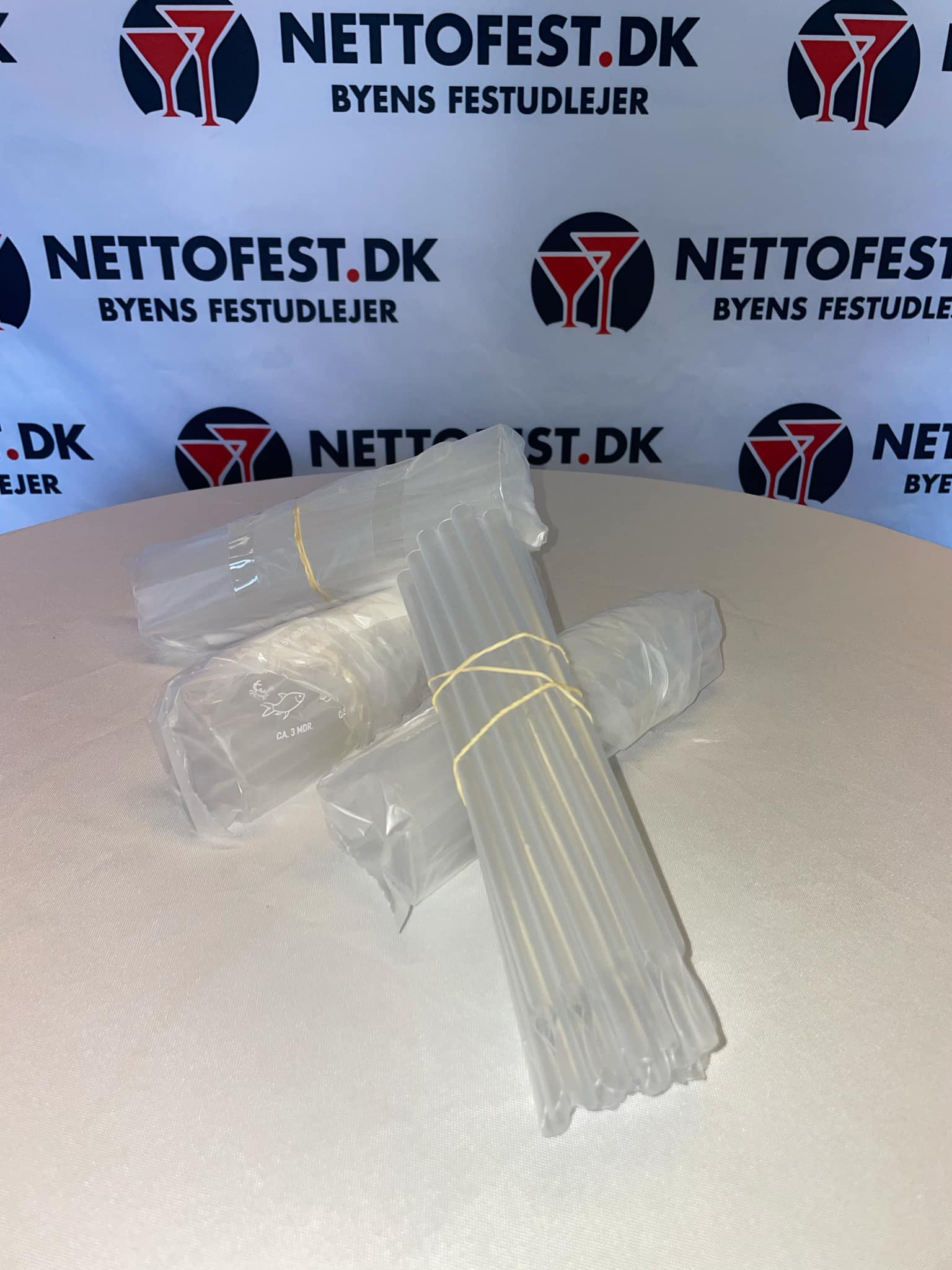 Eight shirts arranged on table in black, olive, grey, blue, white, red, mustard, and green.