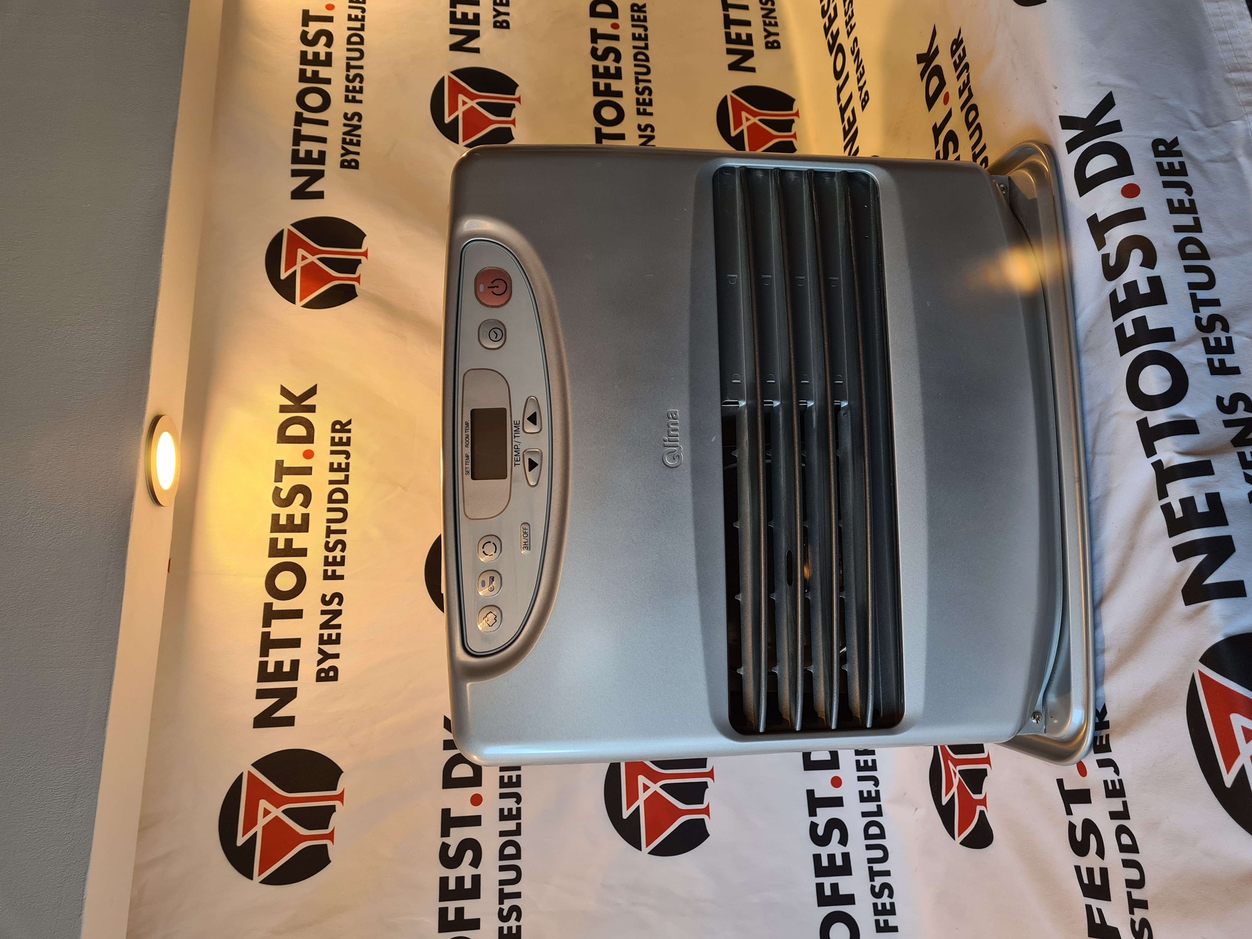 Eight shirts arranged on table in black, olive, grey, blue, white, red, mustard, and green.