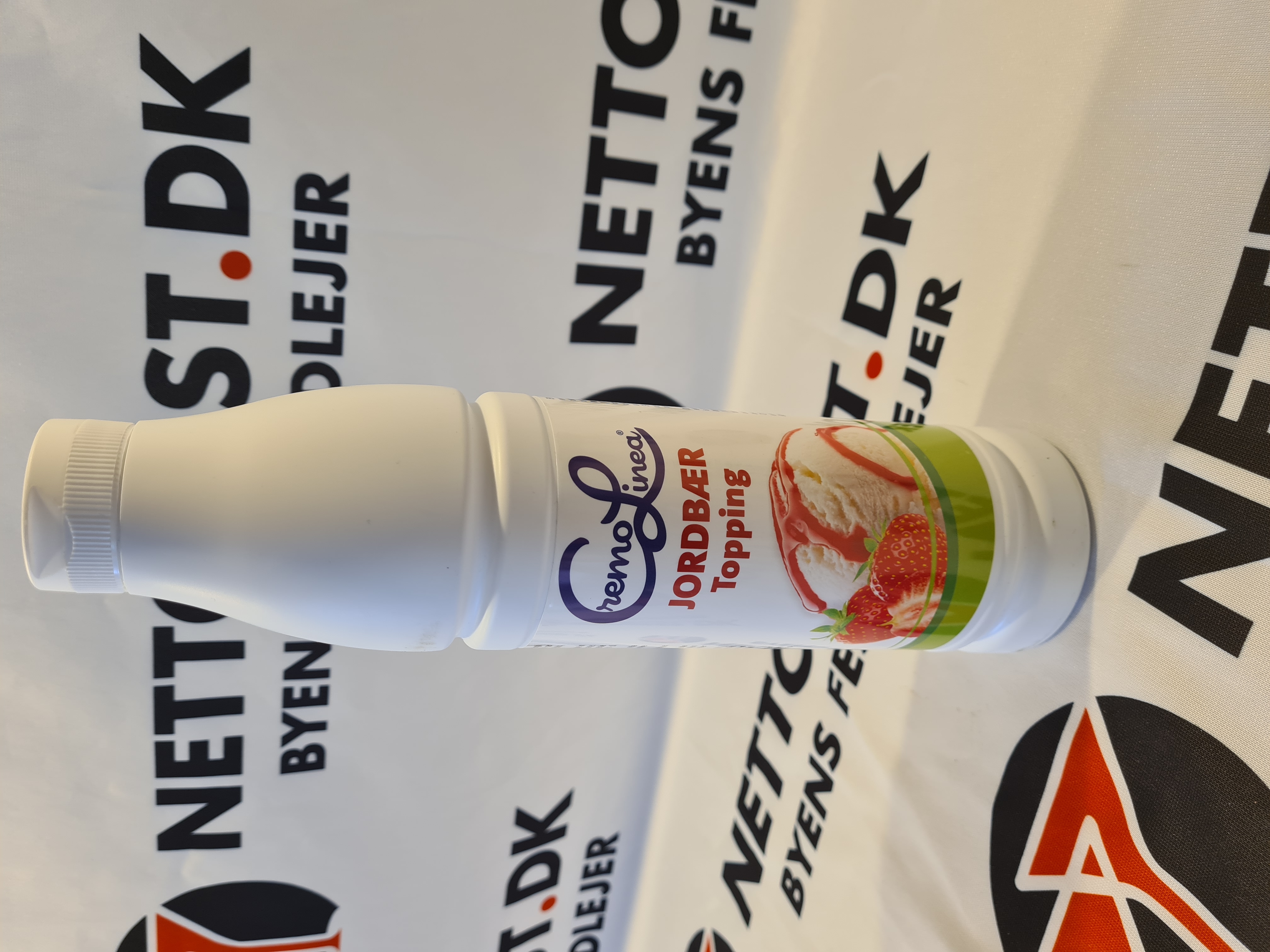 Eight shirts arranged on table in black, olive, grey, blue, white, red, mustard, and green.