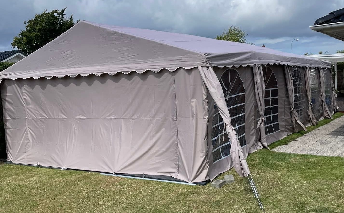 Eight shirts arranged on table in black, olive, grey, blue, white, red, mustard, and green.