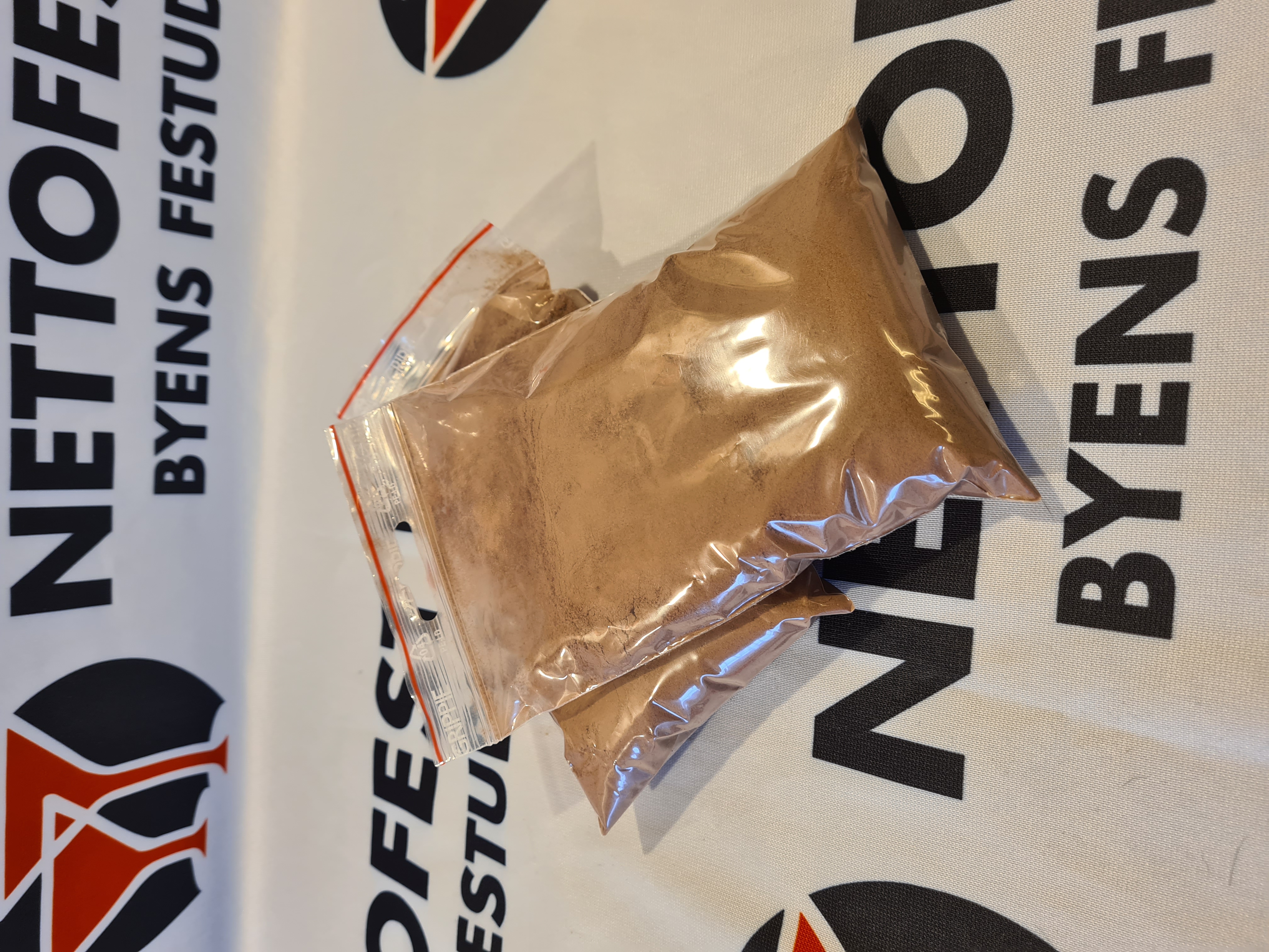 Eight shirts arranged on table in black, olive, grey, blue, white, red, mustard, and green.