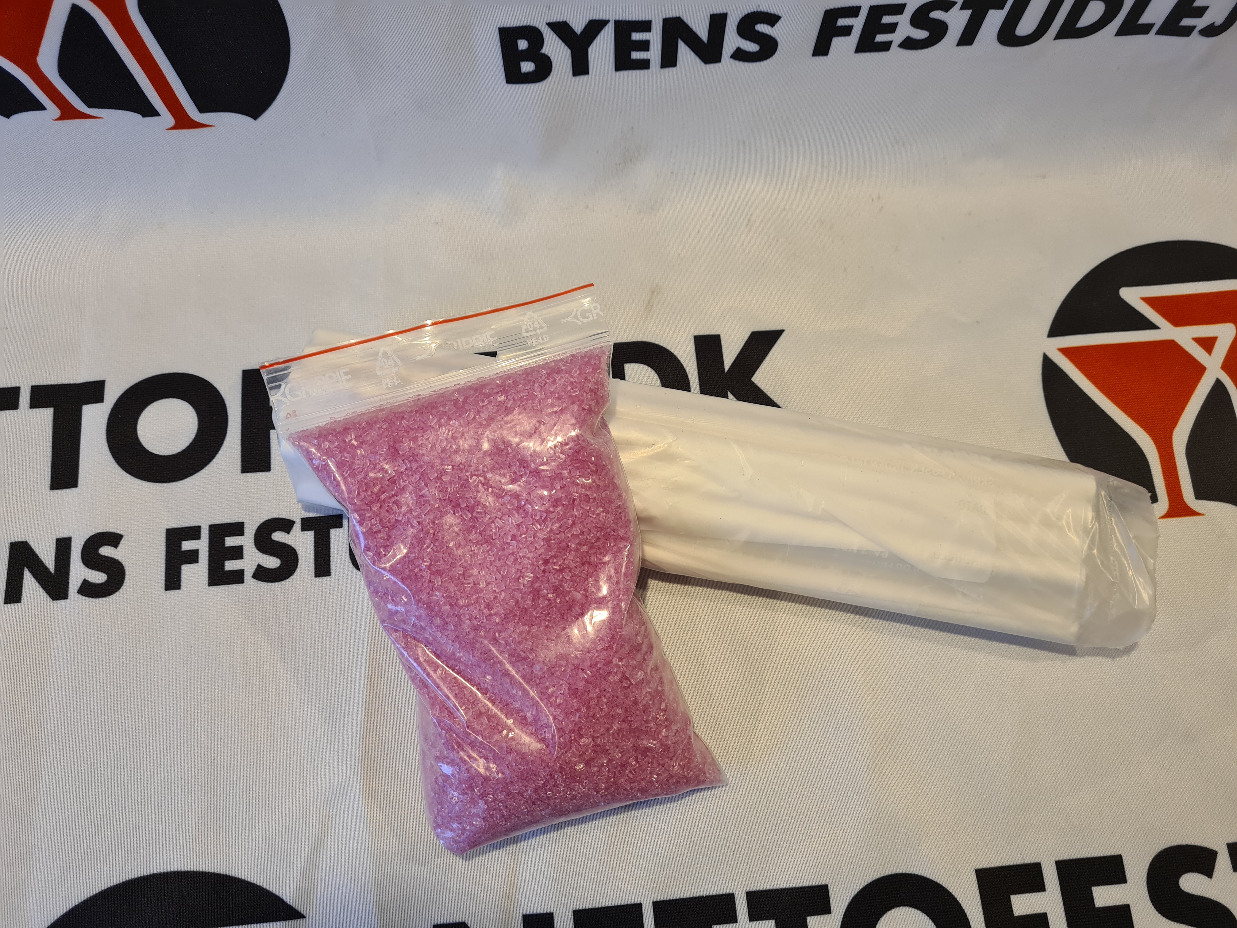 Eight shirts arranged on table in black, olive, grey, blue, white, red, mustard, and green.