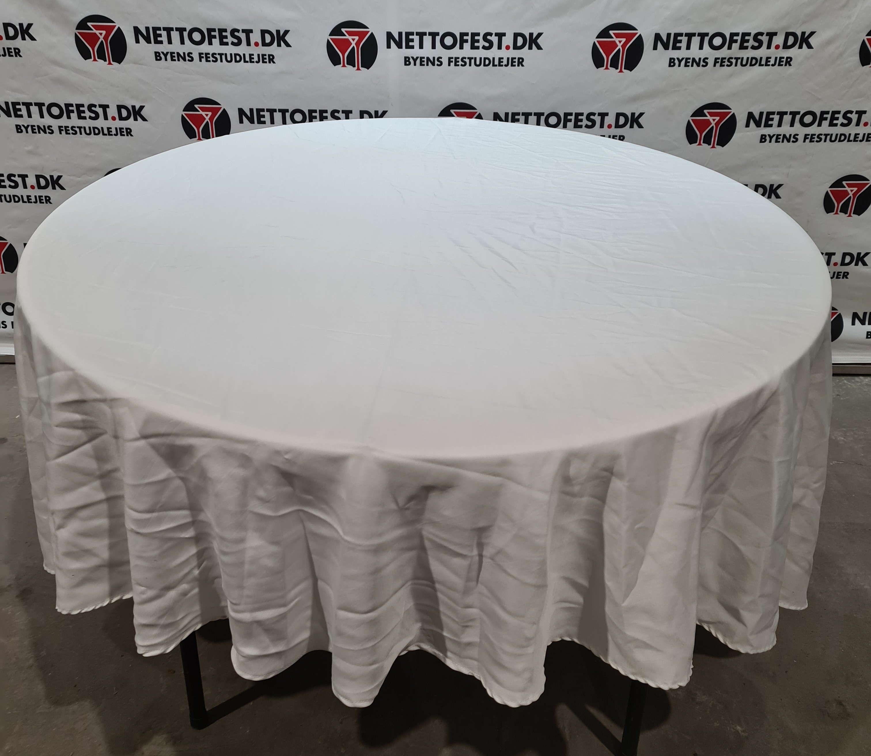 Eight shirts arranged on table in black, olive, grey, blue, white, red, mustard, and green.