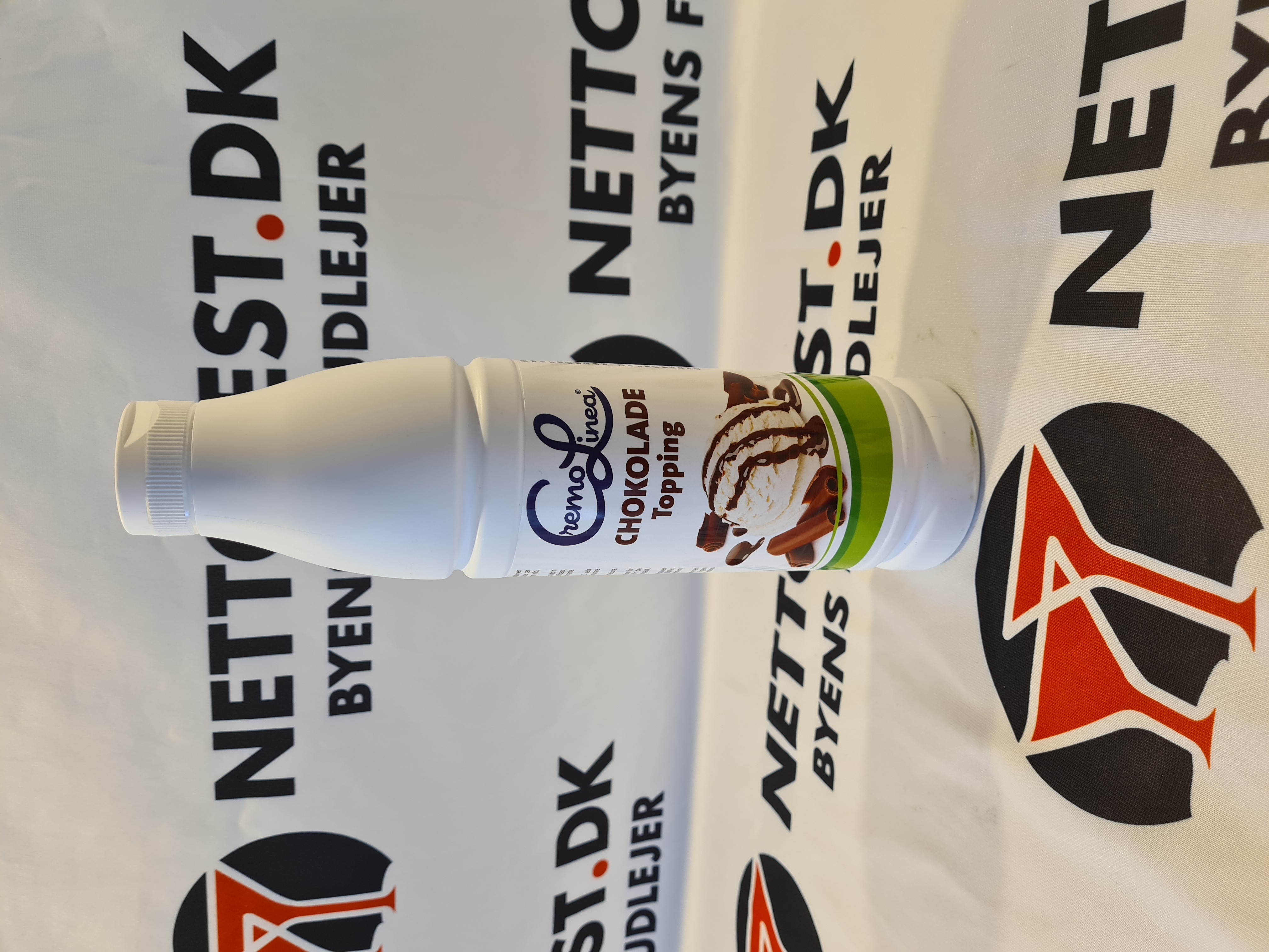 Eight shirts arranged on table in black, olive, grey, blue, white, red, mustard, and green.