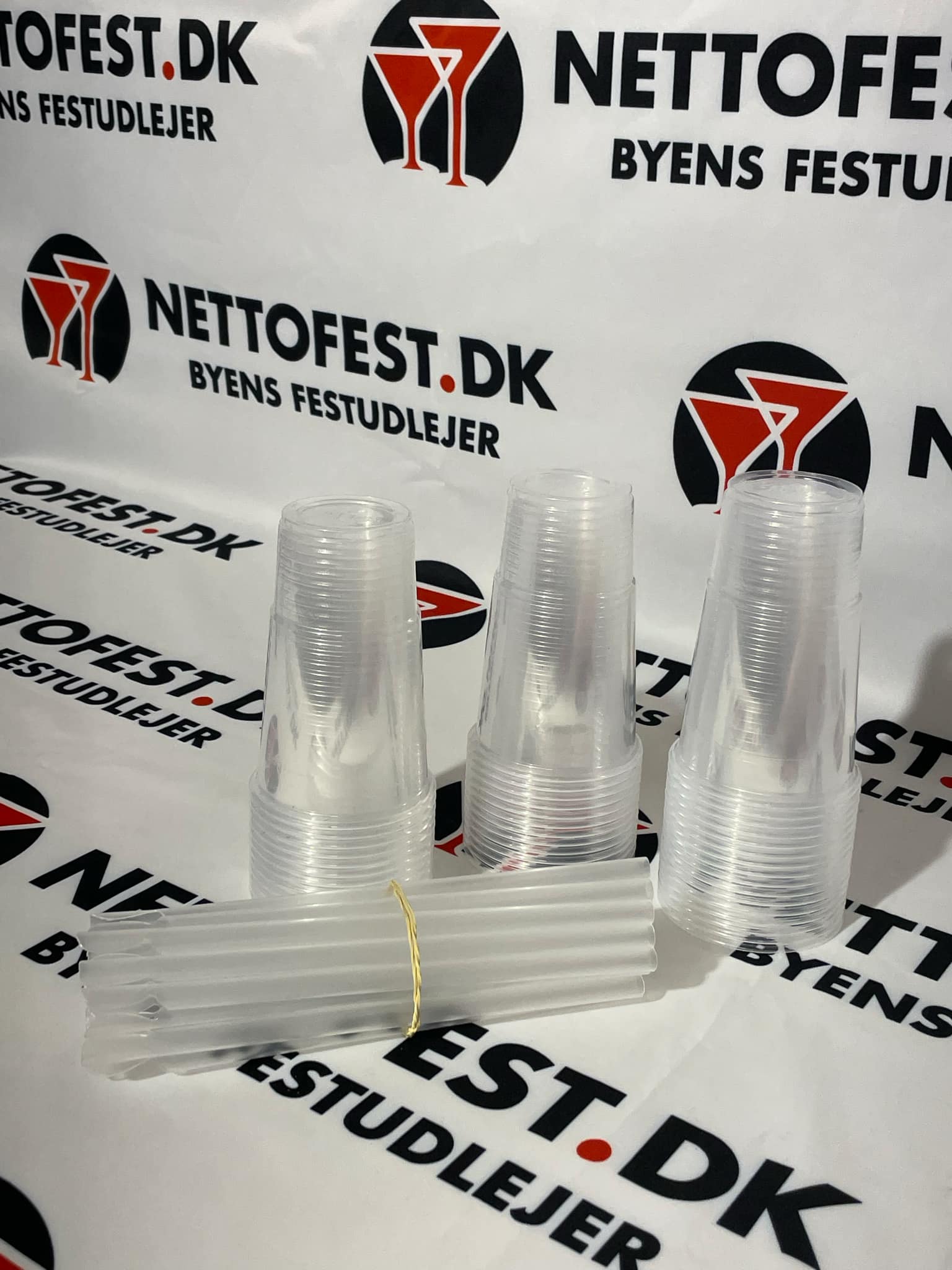 Eight shirts arranged on table in black, olive, grey, blue, white, red, mustard, and green.