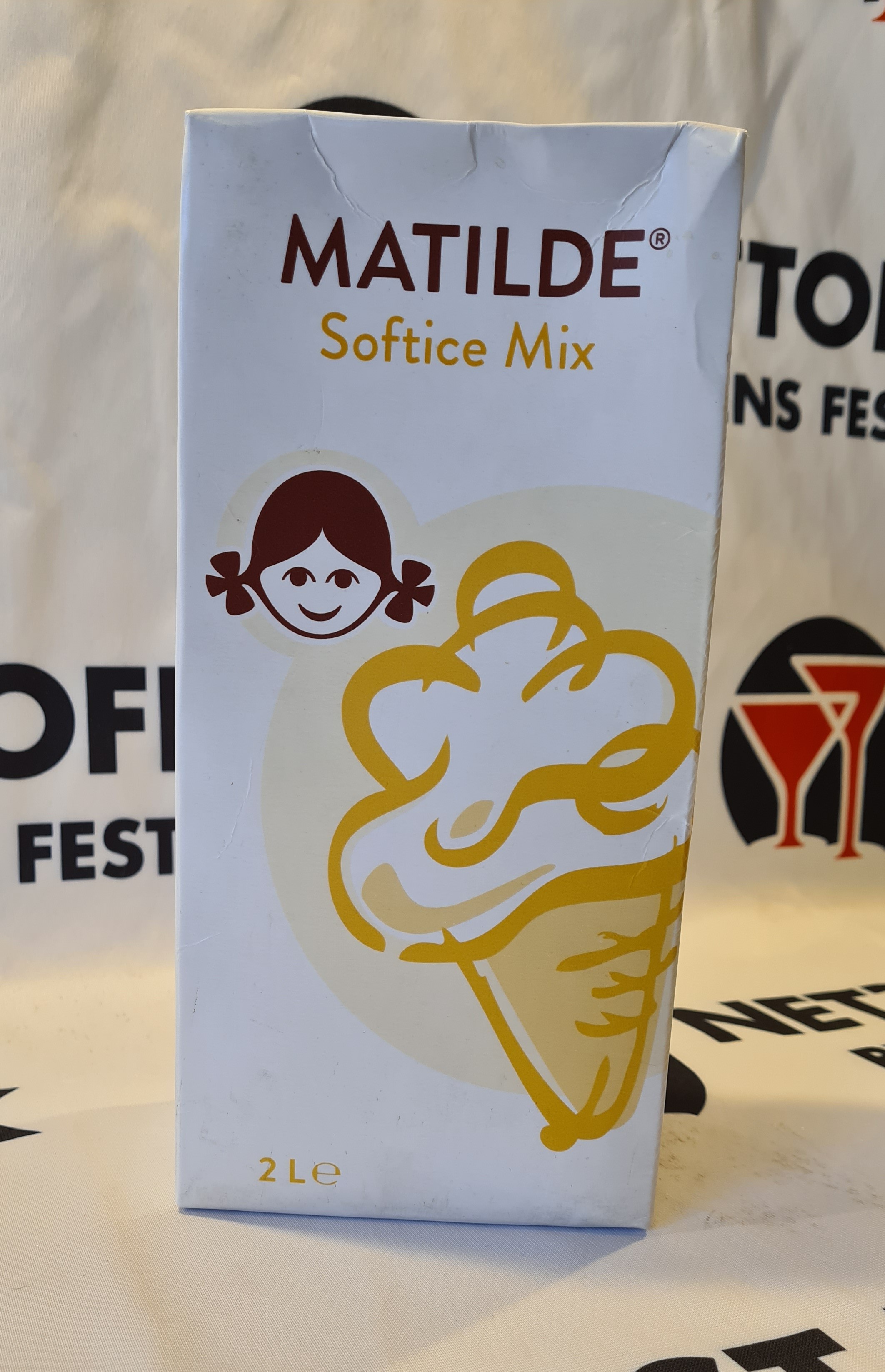 Eight shirts arranged on table in black, olive, grey, blue, white, red, mustard, and green.