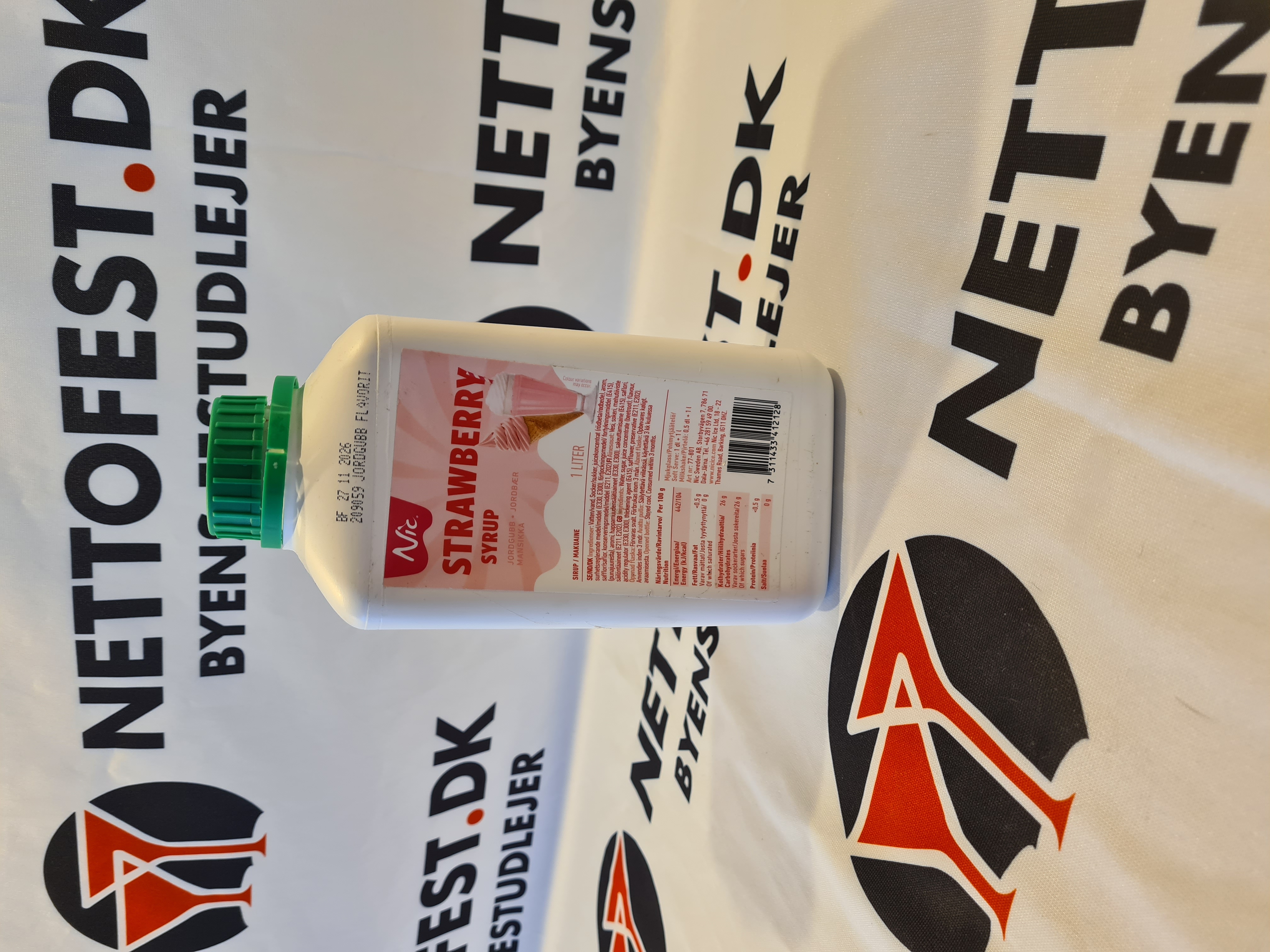 Eight shirts arranged on table in black, olive, grey, blue, white, red, mustard, and green.