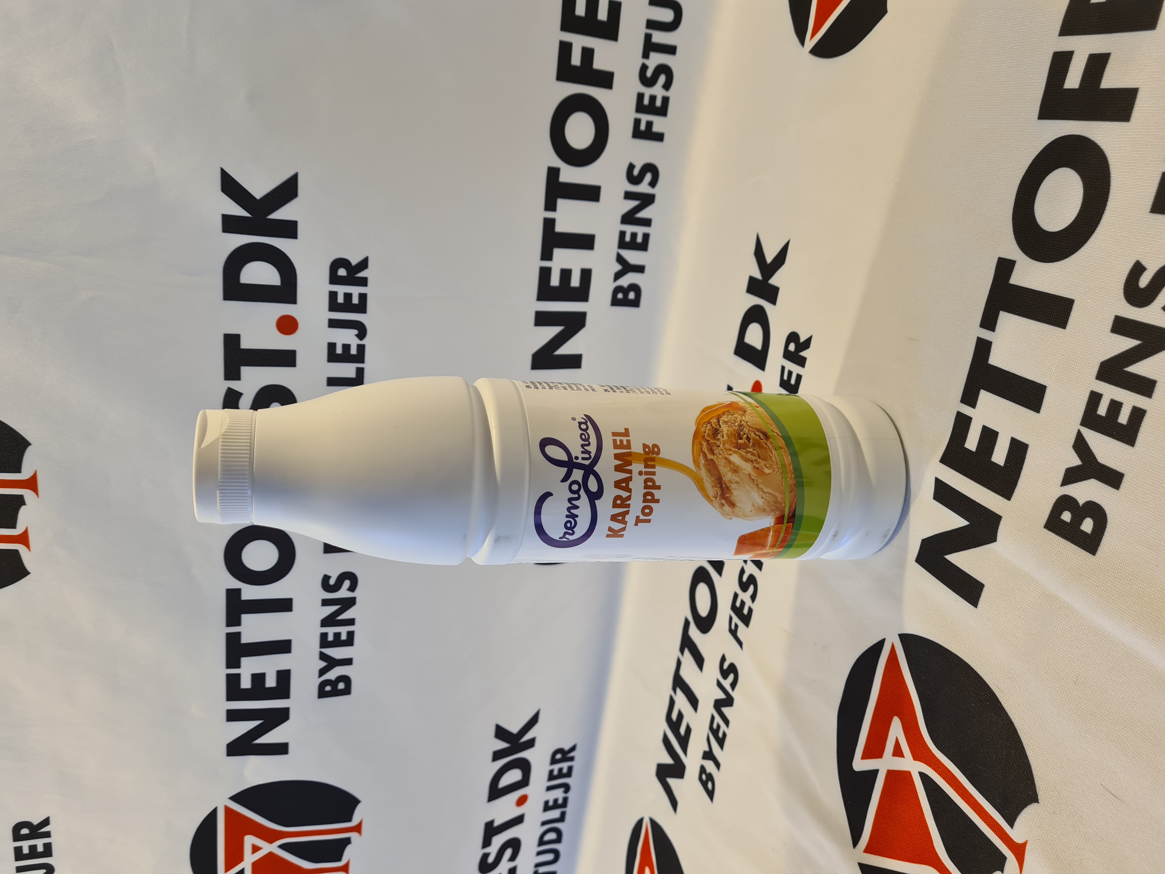 Eight shirts arranged on table in black, olive, grey, blue, white, red, mustard, and green.